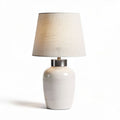 White ceramic table lamp with fabric shade and silver accent 25 x 25 x 50cm